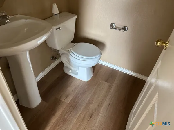 a white toilet sitting next to a sink