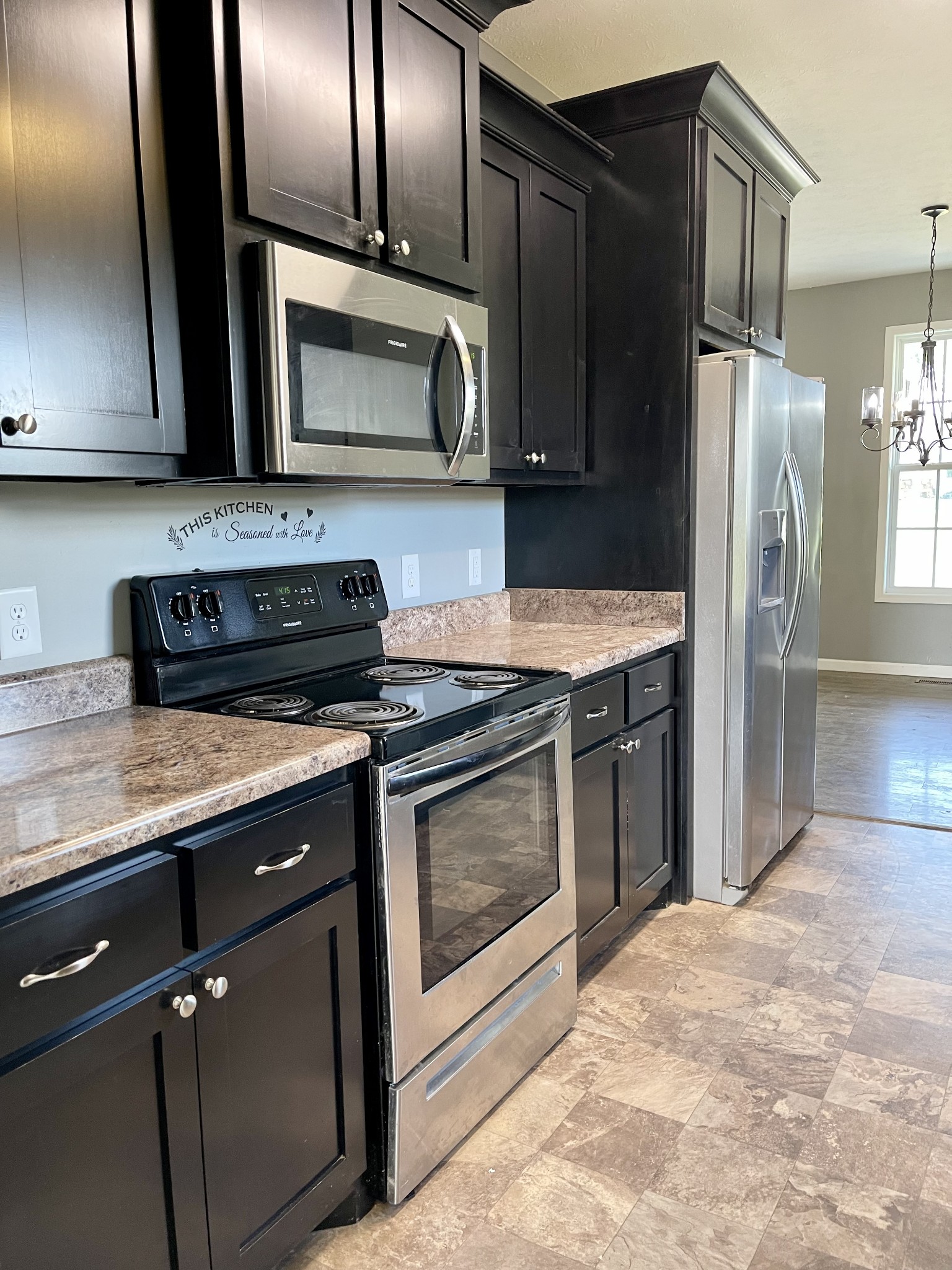 319 Riot Road Portland, TN 37148 - Photo 15 of 26 a kitchen with granite countertop stainless steel appliances and wooden cabinets