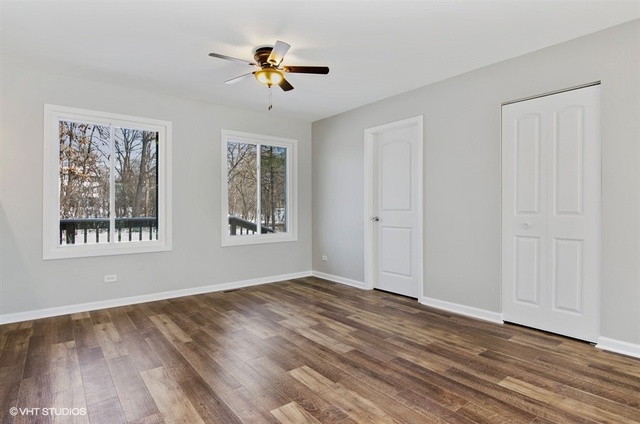 103 Crabtree Road East Dundee, IL 60118 - Photo 14 of 50 a view of empty room with wooden floor and fan