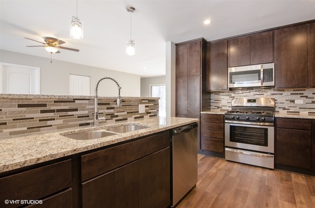 103 Crabtree Road East Dundee, IL 60118 - Photo 3 of 50 a kitchen with stainless steel appliances granite countertop a stove a sink dishwasher a refrigerator and a microwave oven with wooden floor