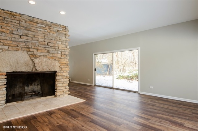 103 Crabtree Road East Dundee, IL 60118 - Photo 7 of 50 an empty room with wooden floor fireplace and windows