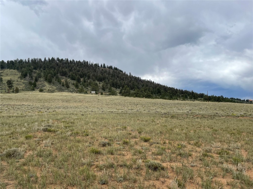 0 Shavano Road Hartsel, CO 80449 - Photo 1 of 8 a view of a lake with houses in the back