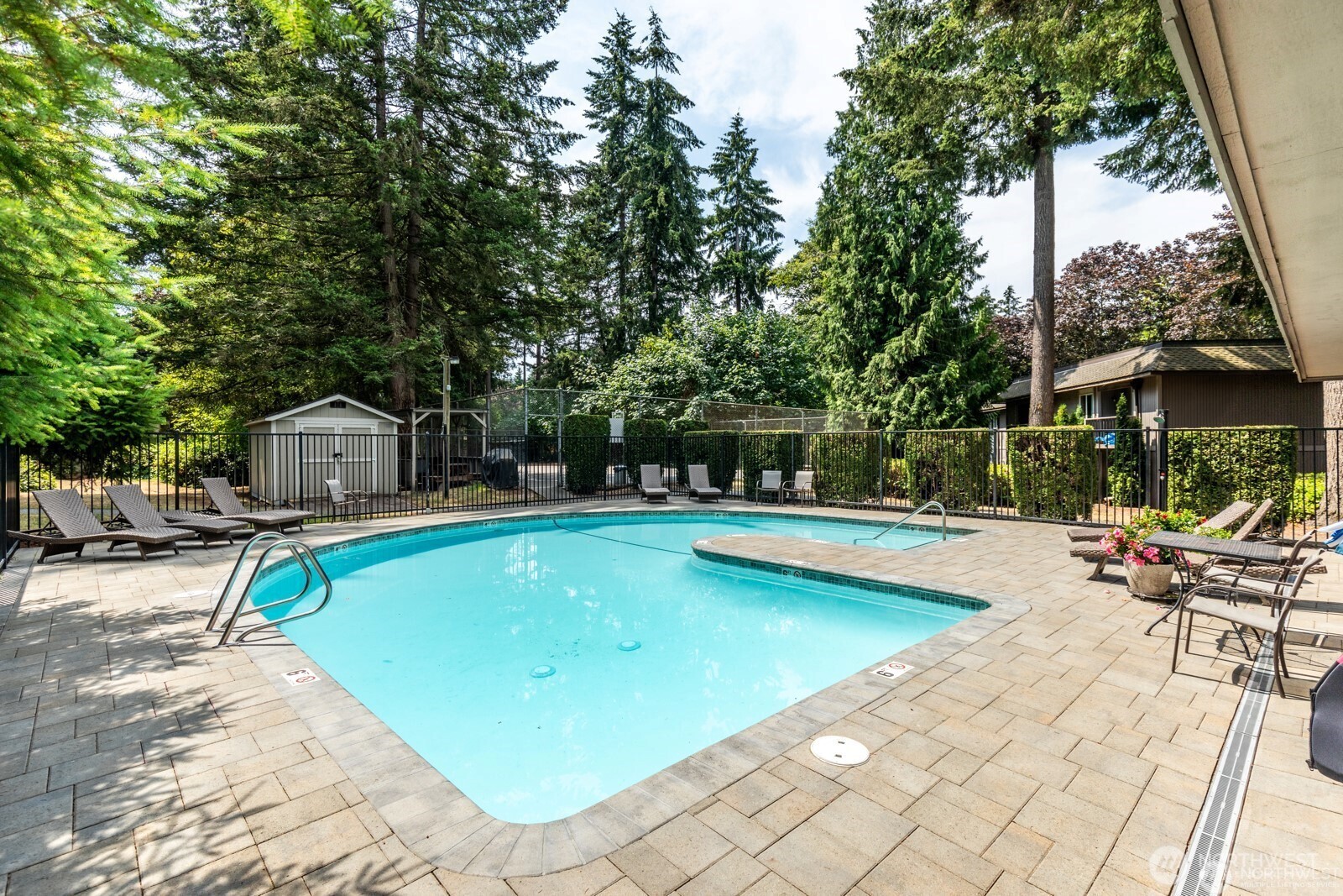 4601 Southwest 320th Street, Unit L6 Federal Way, WA 98023 - Photo 21 of 22 a view of swimming pool with lawn chairs under an umbrella