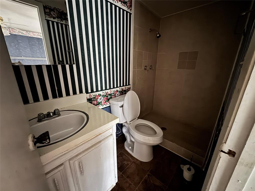 3909 Smothers Road Caney City, TX 75148 - Photo 27 of 35 a bathroom with a sink toilet mirror and vanity