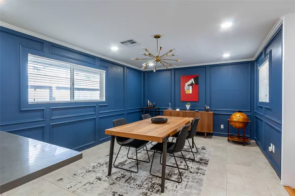 a kitchen with a sink table and chairs