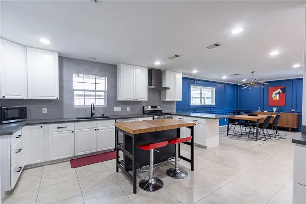 a kitchen with granite countertop cabinets sink and white appliances