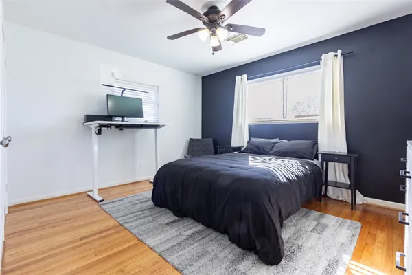 a bedroom with a bed window and a flat screen tv