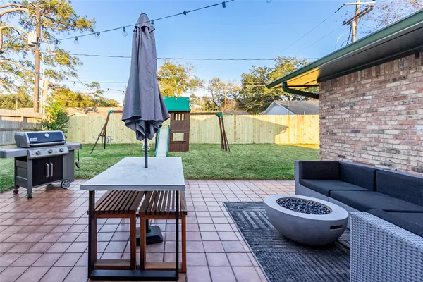 a view of a house with a backyard porch and sitting area