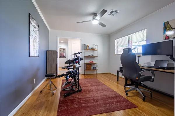 a view of a workspace with furniture and a window