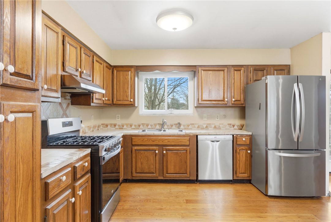 6711 Hamilton-Middletown Road Franklin, OH 45005 - Photo 16 of 49 This welcoming kitchen boasts ample cabinetry and stainless steel appliances, creating a functional cooking space.