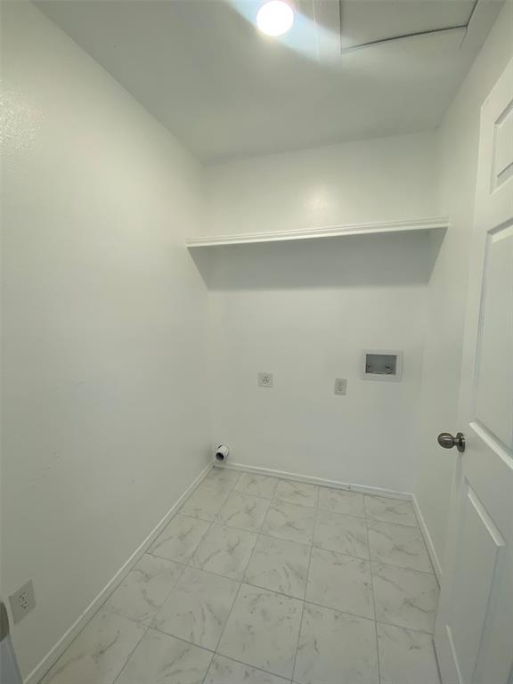 505 Red Springs Avenue Mount Pleasant, TX 75455 - Photo 9 of 9 Washroom with hookup for a washing machine, light marble finish flooring, and hookup for an electric dryer