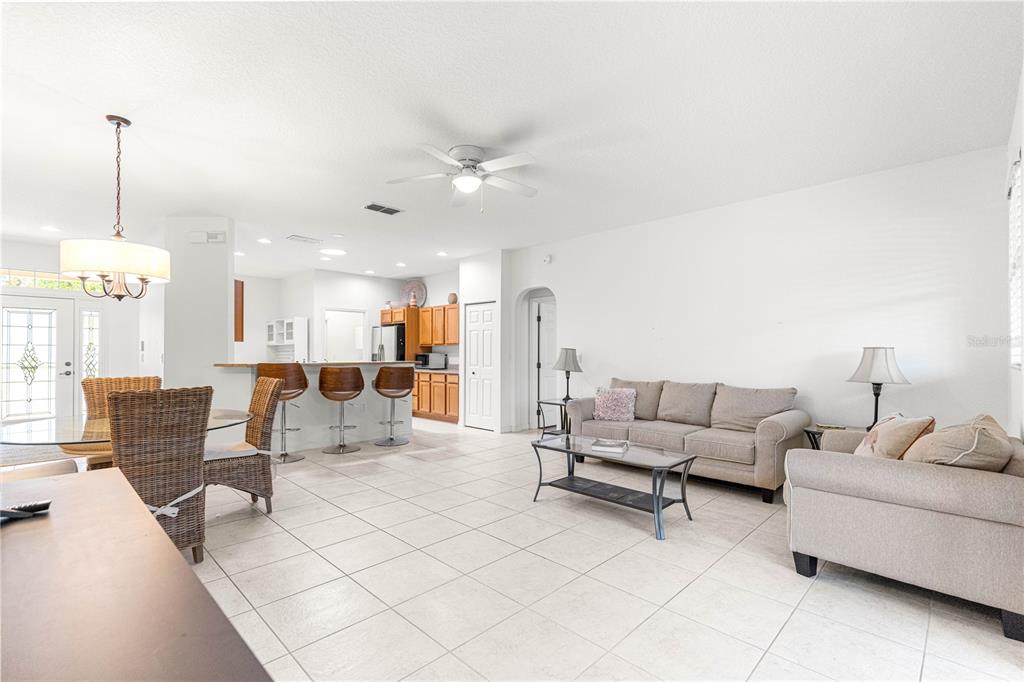 9317 Southwest 94th Loop Ocala, FL 34481 - Photo 5 of 40 a living room with furniture and a chandelier