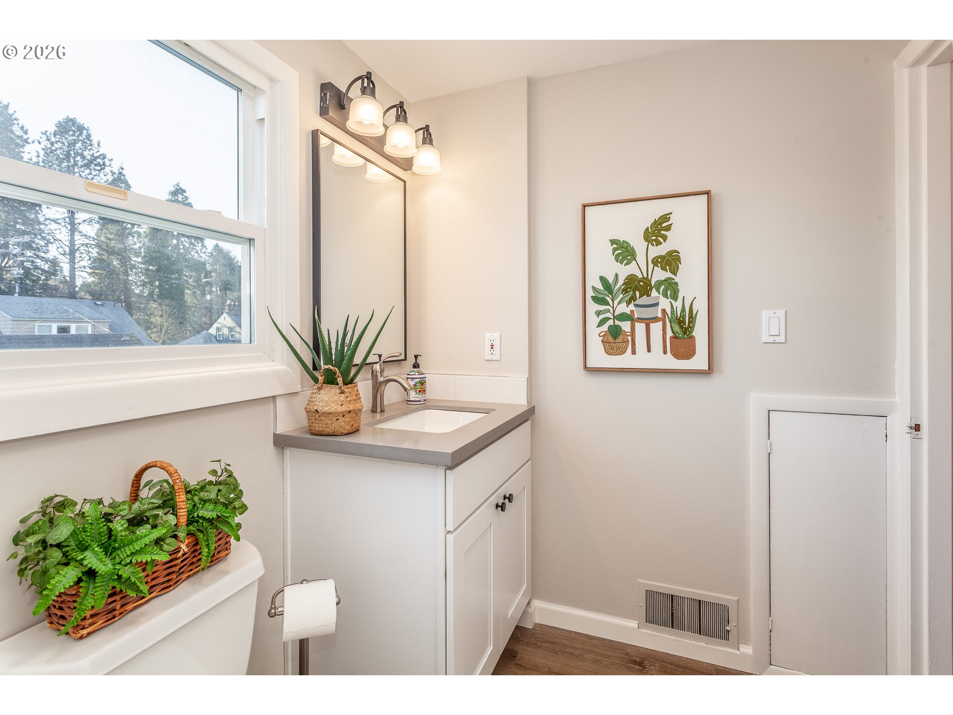 4760 North Harvard Street Portland, OR 97203 - Photo 18 of 43 a bathroom with a sink a mirror and a potted plant