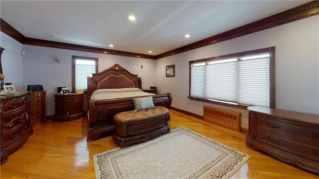 a living room with furniture a bed and wooden floor