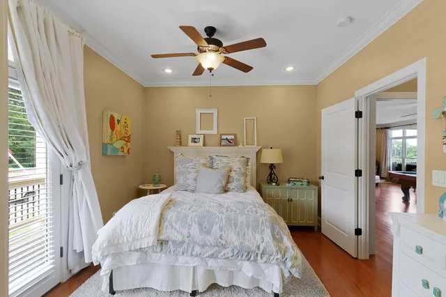 a bed room with a bed and a ceiling fan