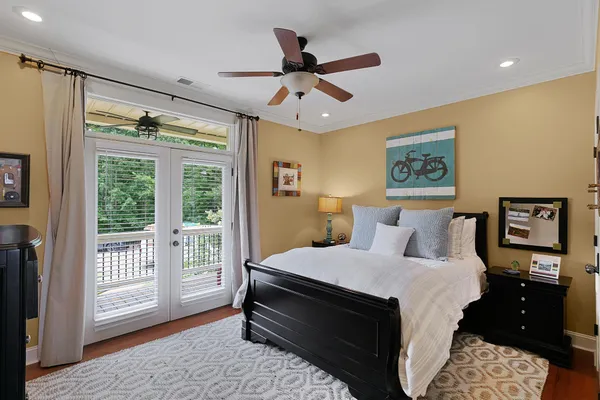 a bedroom with a bed and wooden floor