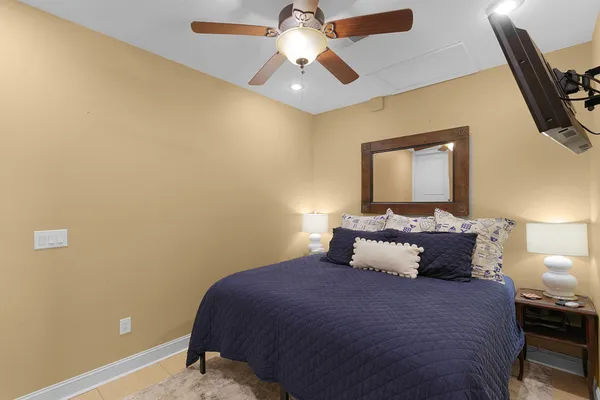 a bedroom with a bed and a chandelier