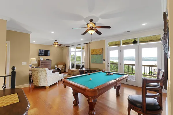 a room with furniture pool table and windows