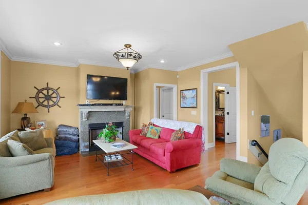 a living room with furniture a fireplace and a flat screen tv