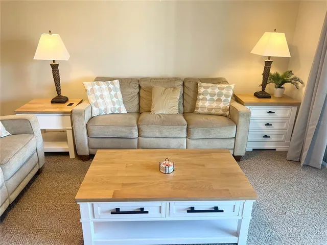 a living room with a bed furniture and a lamp