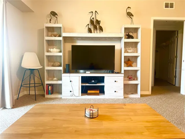 a living room with a flat screen tv and a fireplace