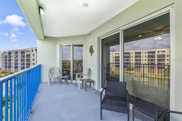 a balcony with table and chairs