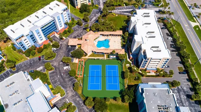 an aerial view of a residential apartment building with a yard