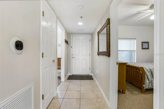 a view of hallway with walk in closet and mirror