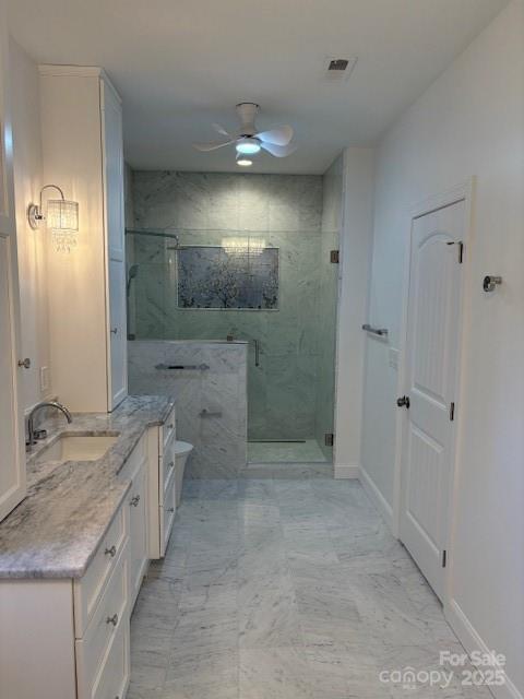 73 Wisdom Cove Road Flat Rock, NC 28731 - Photo 17 of 41 a bathroom with a granite countertop sink a toilet and shower