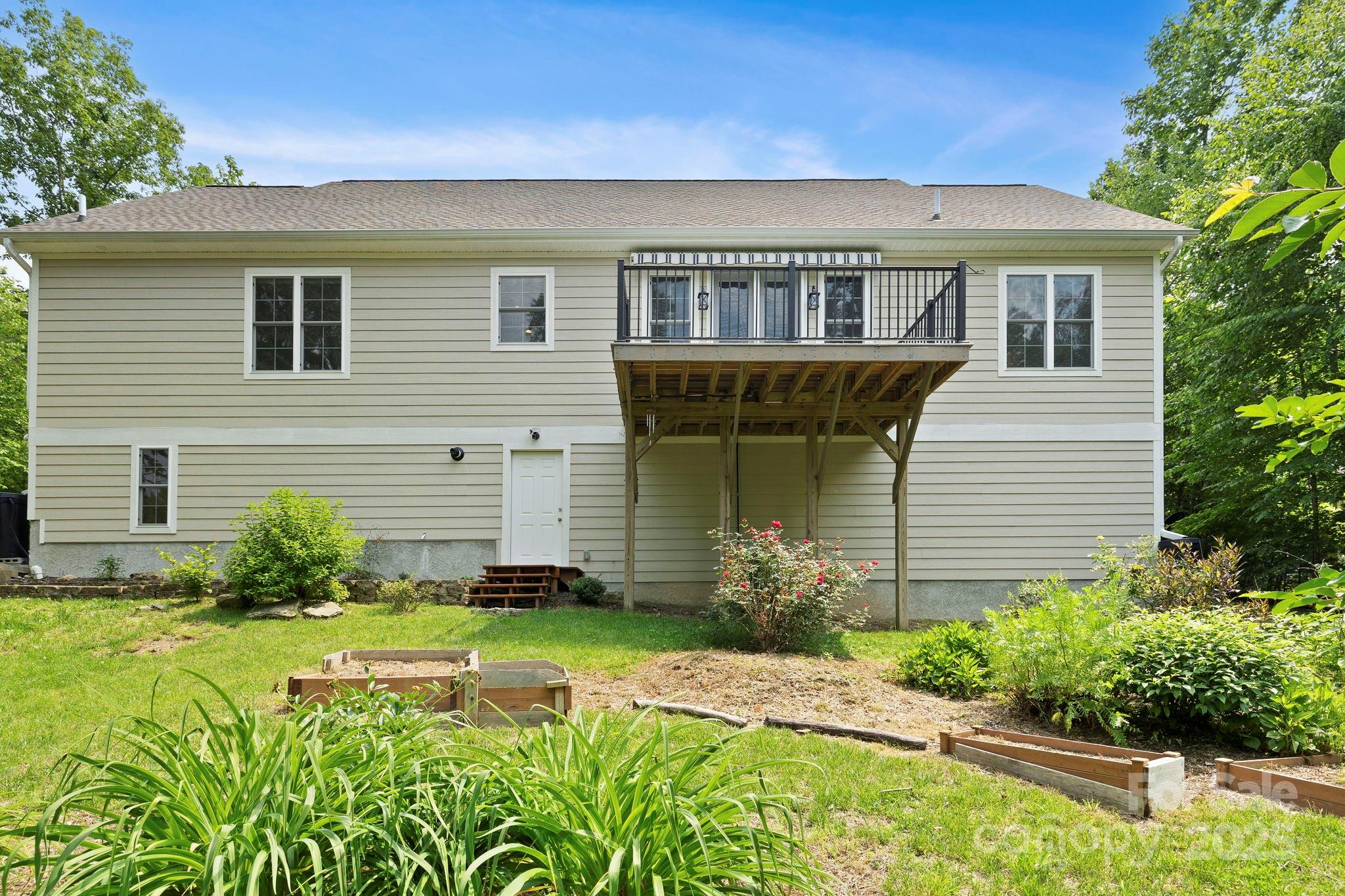 73 Wisdom Cove Road Flat Rock, NC 28731 - Photo 31 of 41 a front view of a house with garden