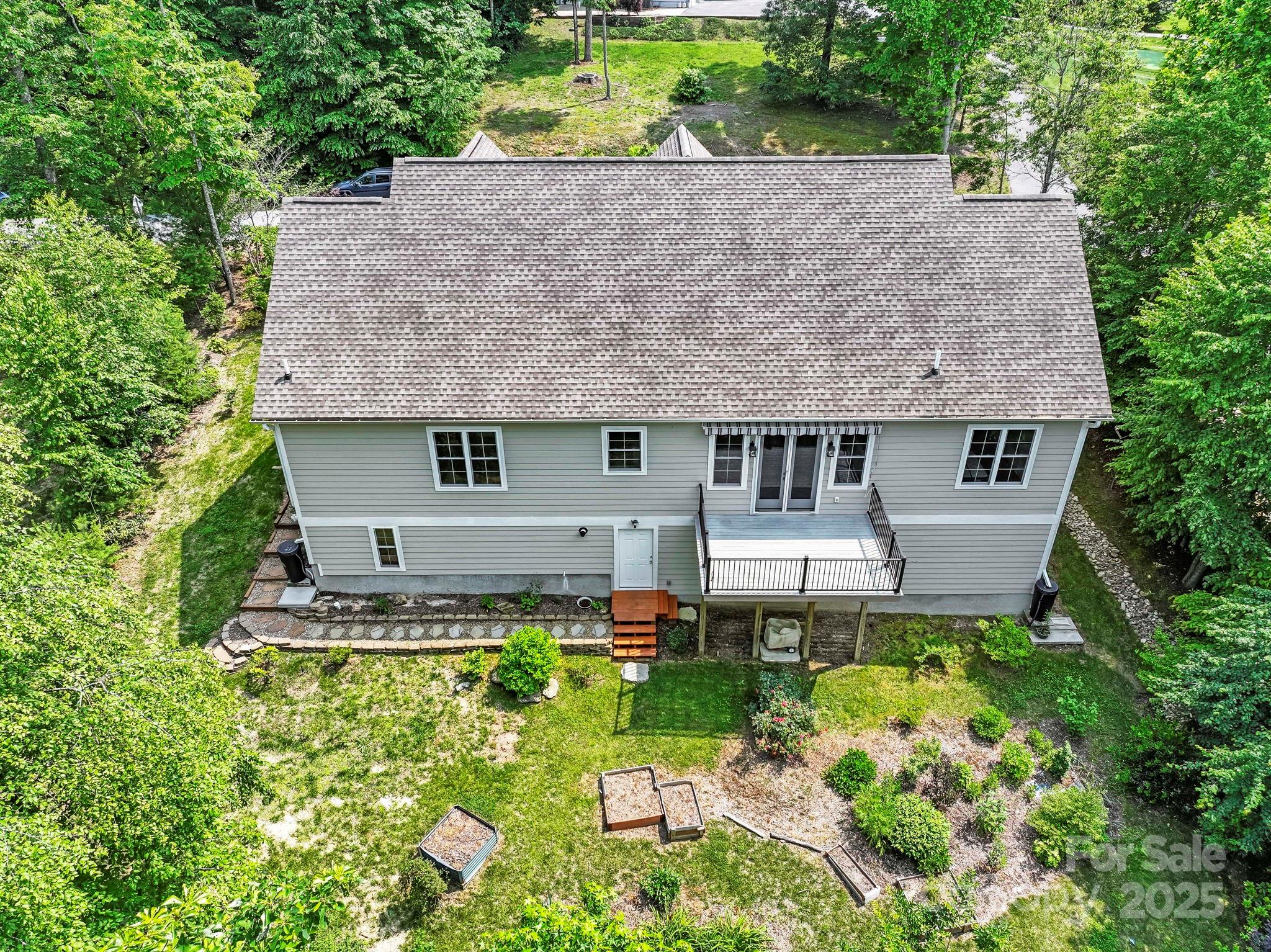 73 Wisdom Cove Road Flat Rock, NC 28731 - Photo 32 of 41 aerial view of a house with a yard and potted plants
