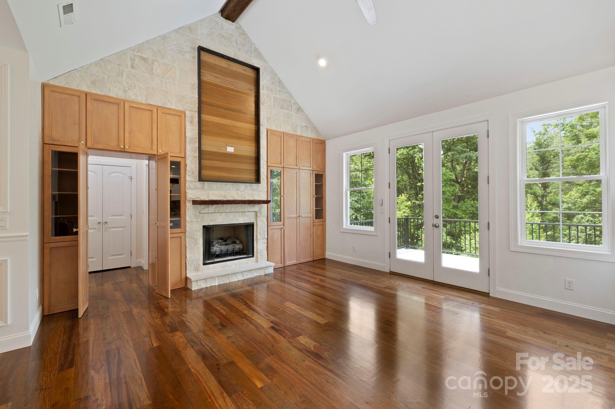 73 Wisdom Cove Road Flat Rock, NC 28731 - Photo 7 of 41 a view of a livingroom with wooden floor a fireplace and window
