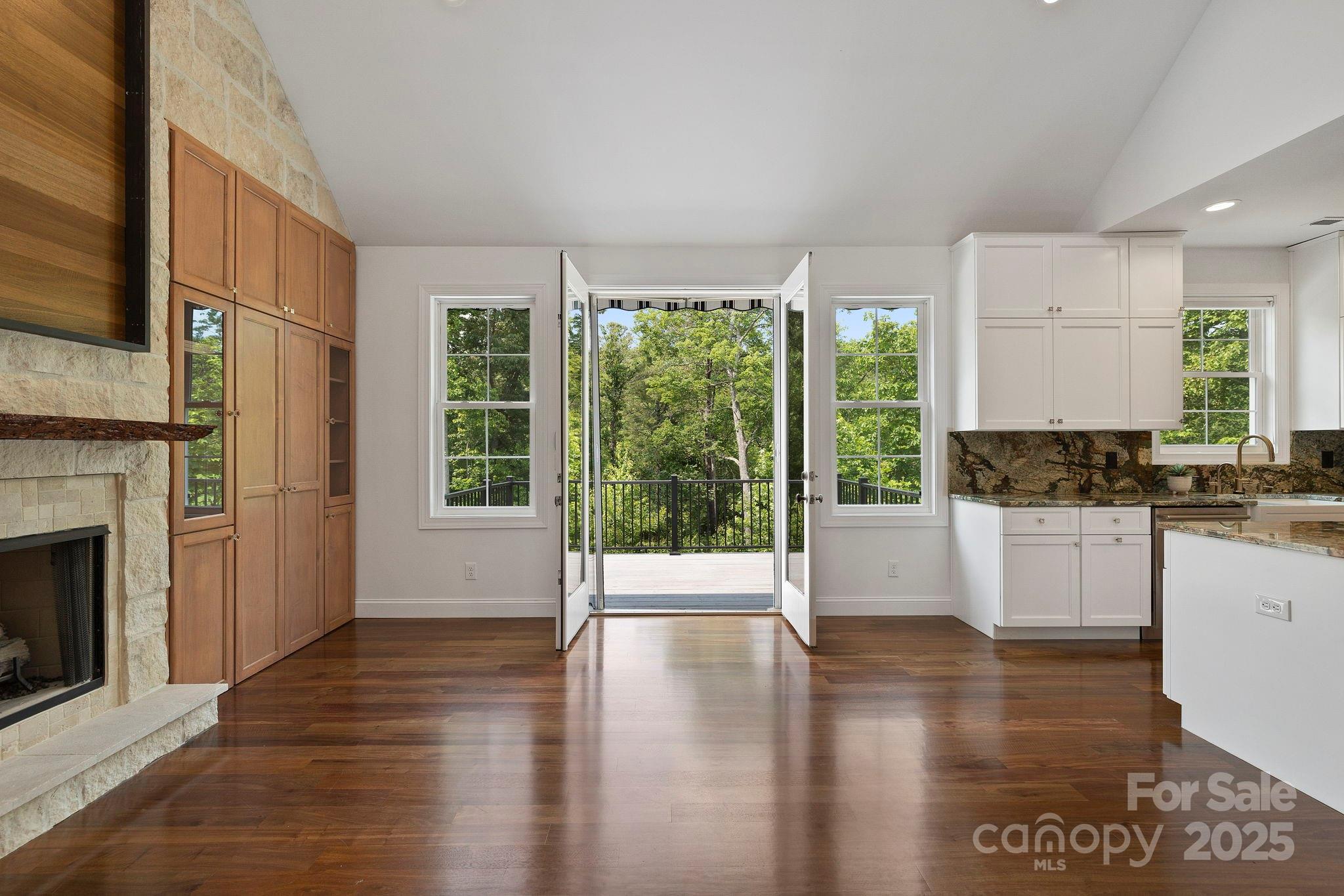 73 Wisdom Cove Road Flat Rock, NC 28731 - Photo 9 of 41 a open kitchen with granite countertop a stove top oven a sink and a wooden floors