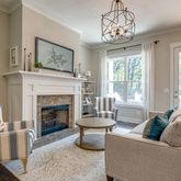 a living room with furniture a window and a fireplace