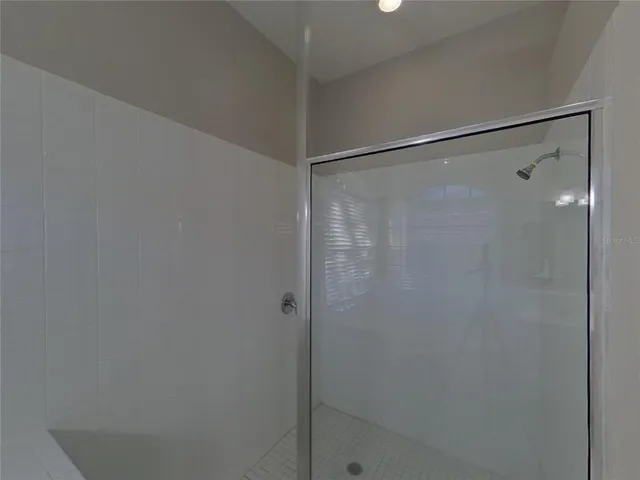 a bathroom with a glass shower door