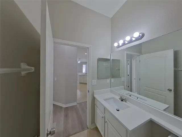 a bathroom with a bathtub a sink and a mirror