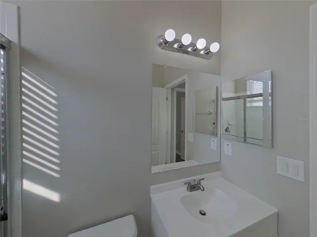 a bathroom with a sink vanity and a mirror