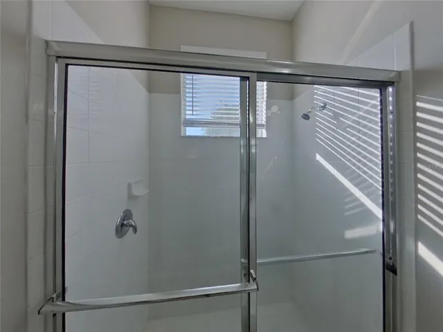 a bathroom with a glass shower door