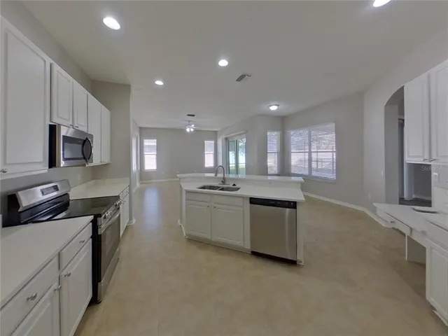 a kitchen with a sink stove and microwave