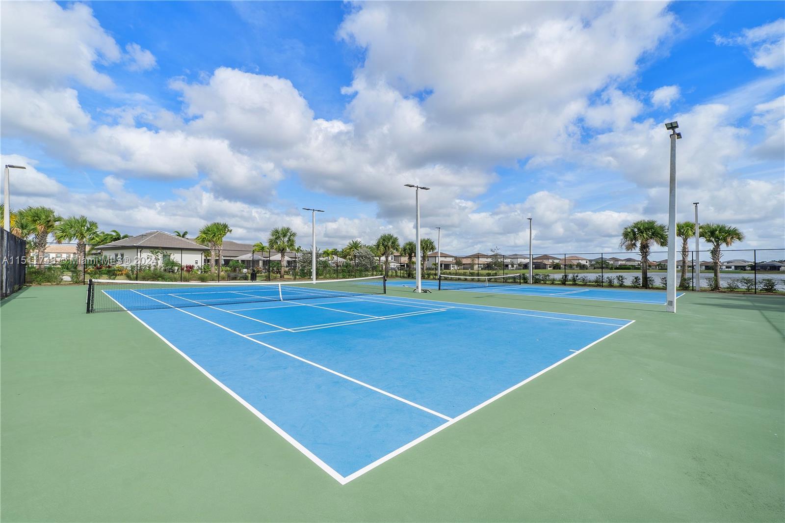 8339 Cadre Noir Road Lake Worth, FL 33467 - Photo 11 of 44 a view of a tennis court