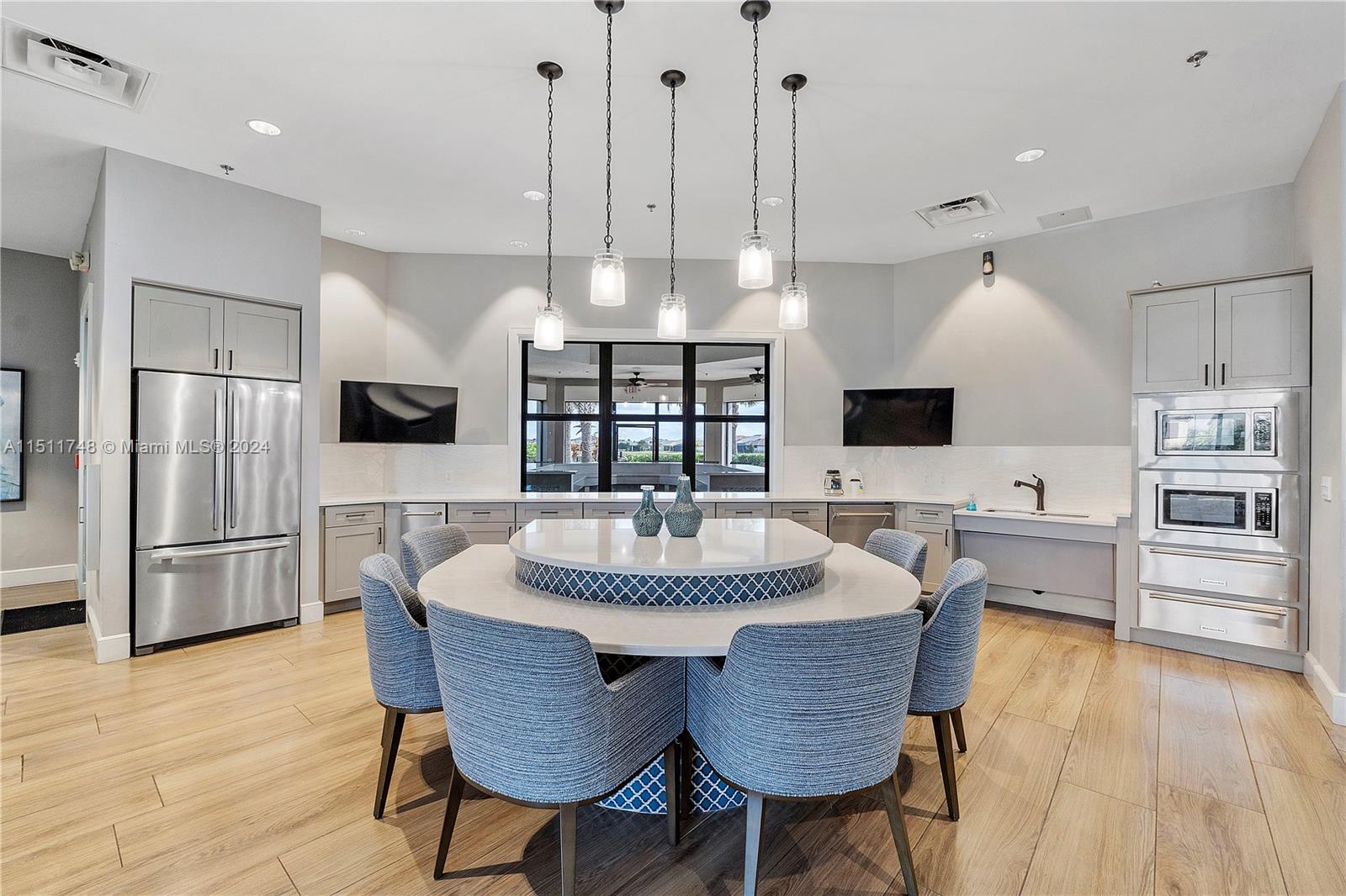 8339 Cadre Noir Road Lake Worth, FL 33467 - Photo 17 of 44 a large kitchen with a table and chairs