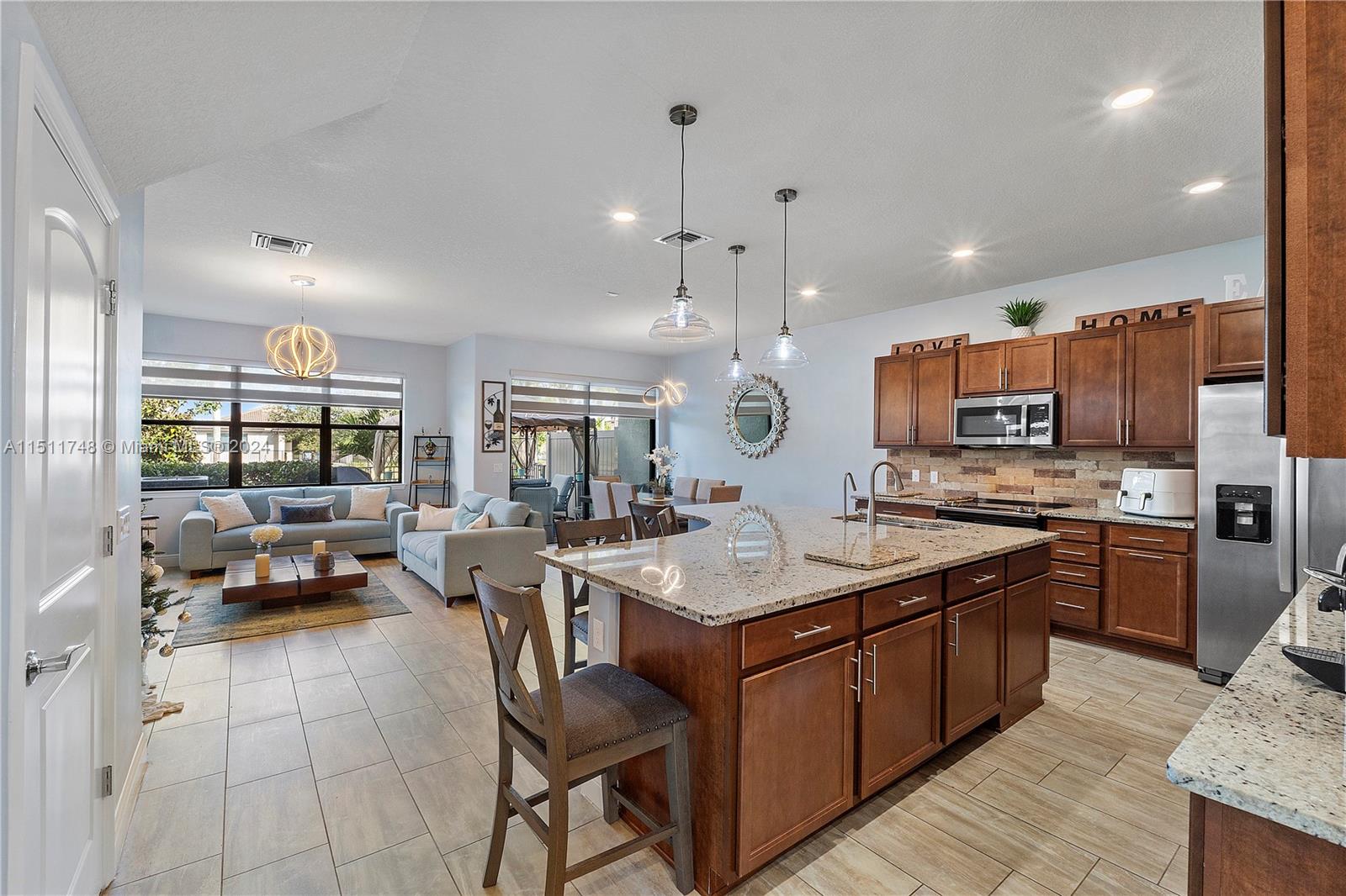 8339 Cadre Noir Road Lake Worth, FL 33467 - Photo 2 of 44 a kitchen with a sink stove and cabinets