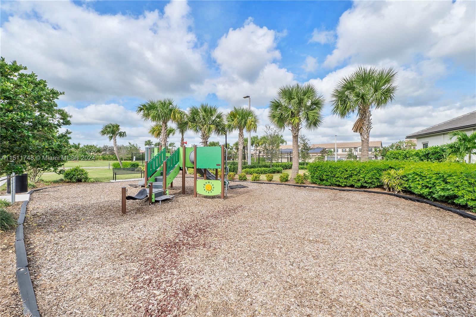 8339 Cadre Noir Road Lake Worth, FL 33467 - Photo 21 of 44 a view of a park with swings and slides
