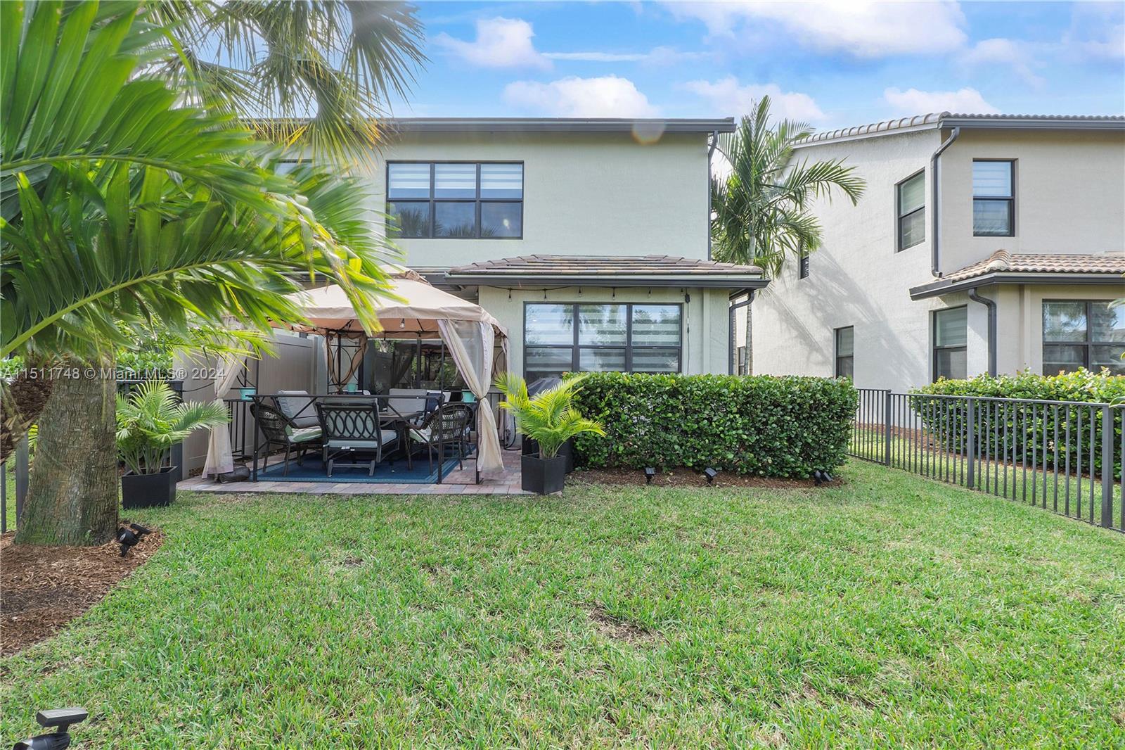 8339 Cadre Noir Road Lake Worth, FL 33467 - Photo 25 of 44 a view of a house with a yard and sitting area
