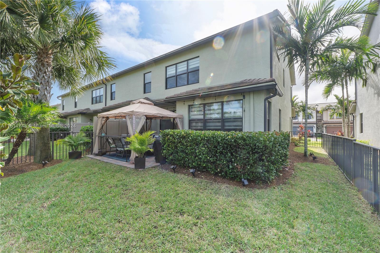 8339 Cadre Noir Road Lake Worth, FL 33467 - Photo 26 of 44 a view of a house with a yard and sitting area