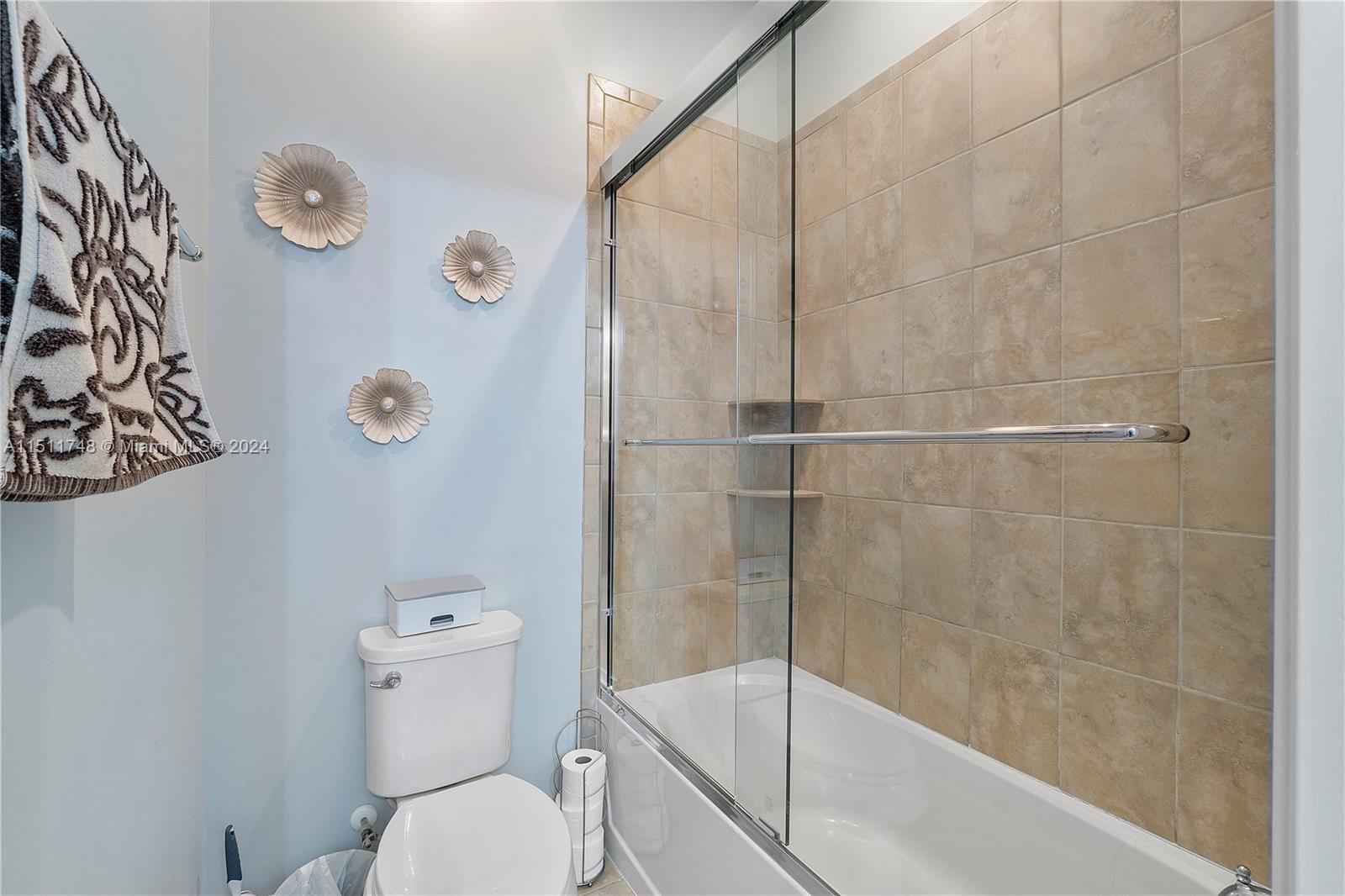 8339 Cadre Noir Road Lake Worth, FL 33467 - Photo 27 of 44 a bathroom with a shower a toilet and a sink