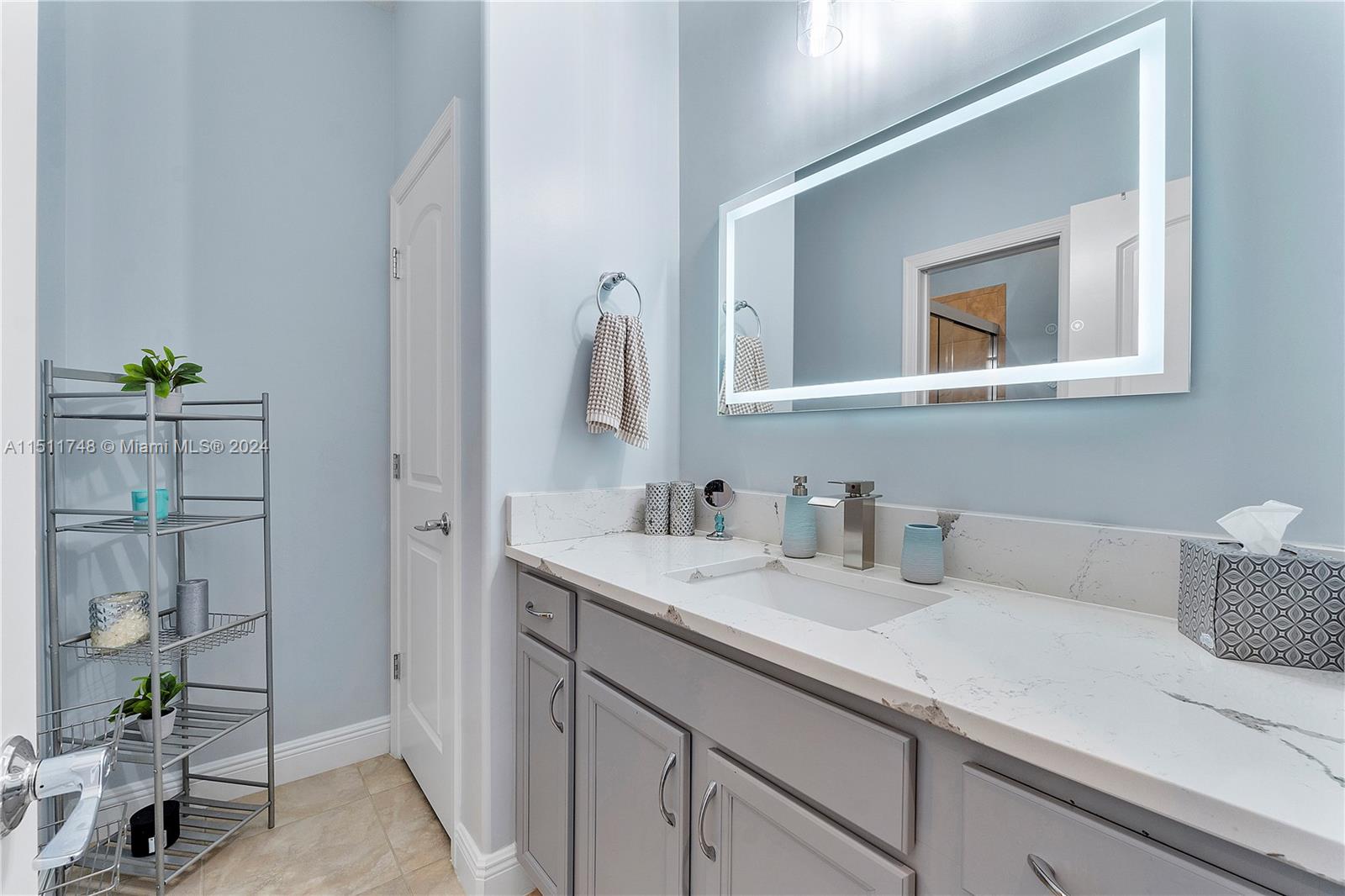8339 Cadre Noir Road Lake Worth, FL 33467 - Photo 28 of 44 a bathroom with a sink and a mirror