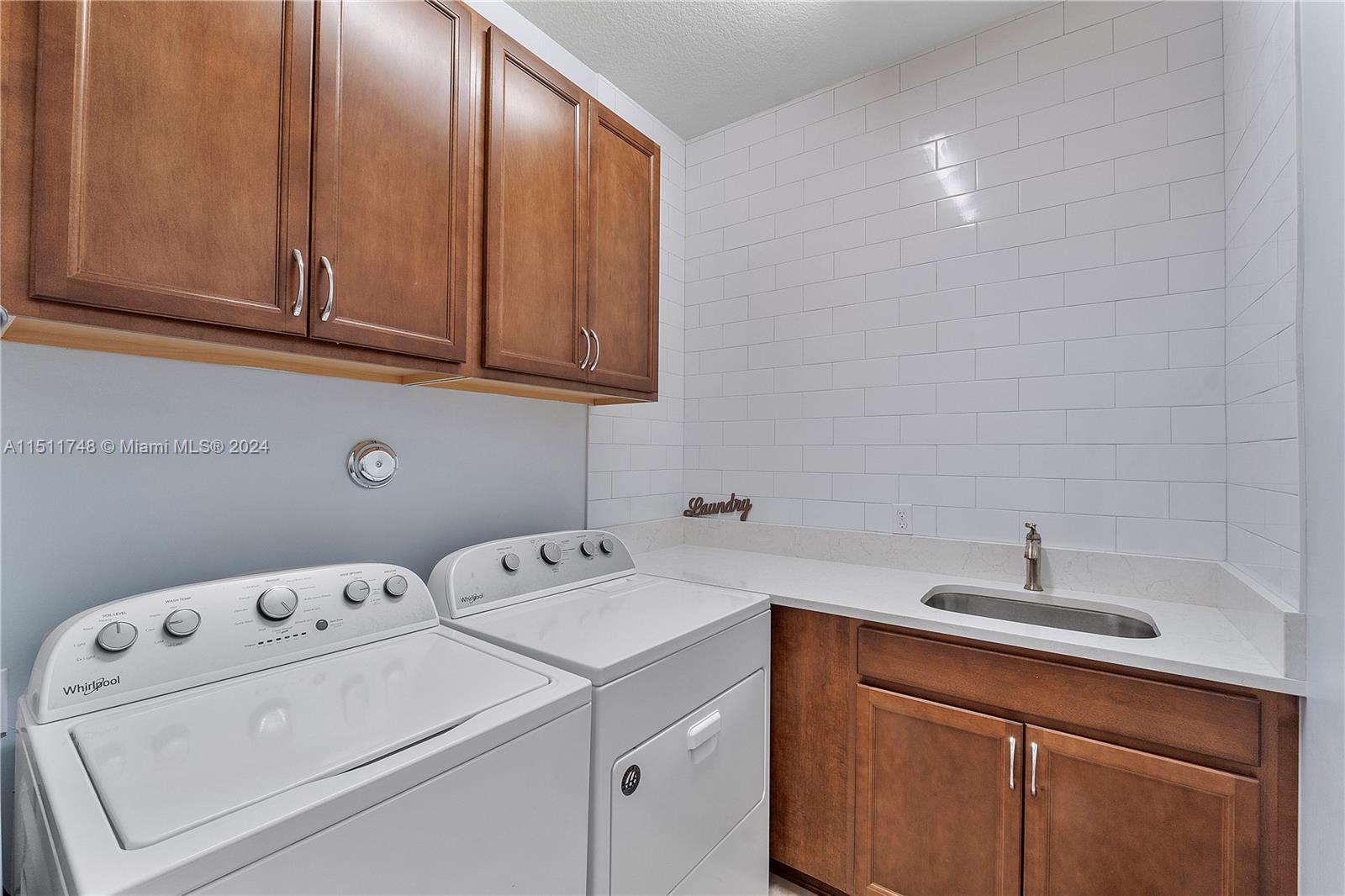 8339 Cadre Noir Road Lake Worth, FL 33467 - Photo 29 of 44 a utility room with dryer and washer