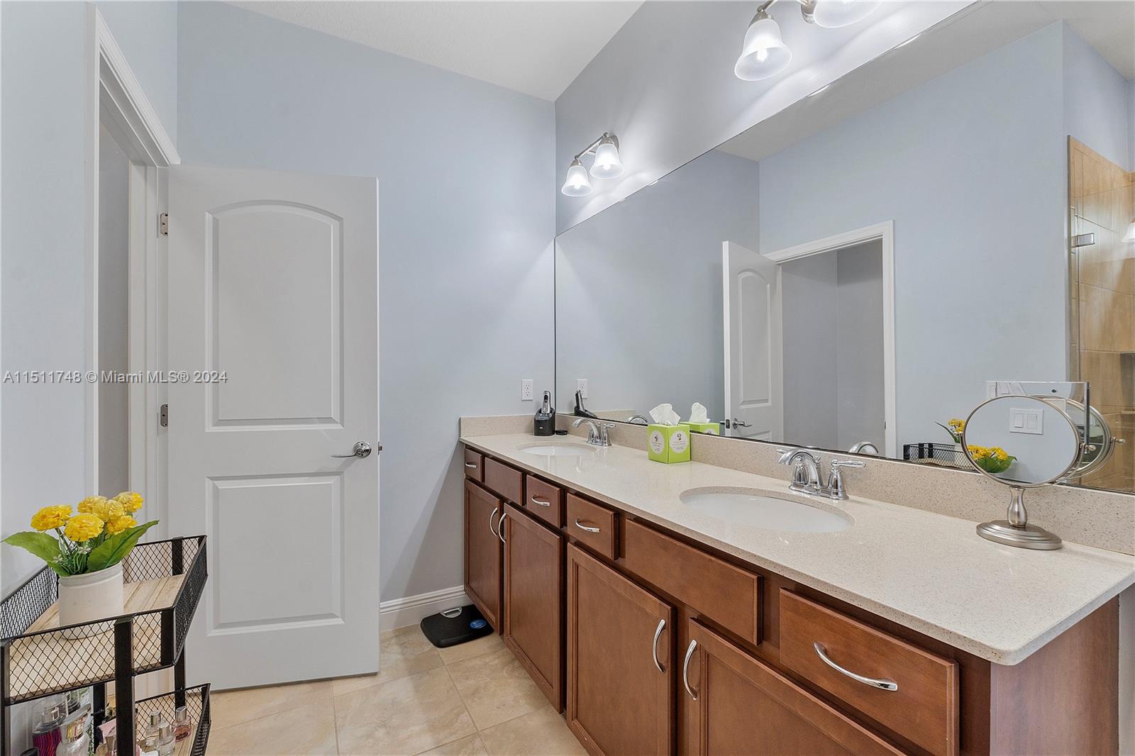 8339 Cadre Noir Road Lake Worth, FL 33467 - Photo 32 of 44 a bathroom with a sink and a mirror