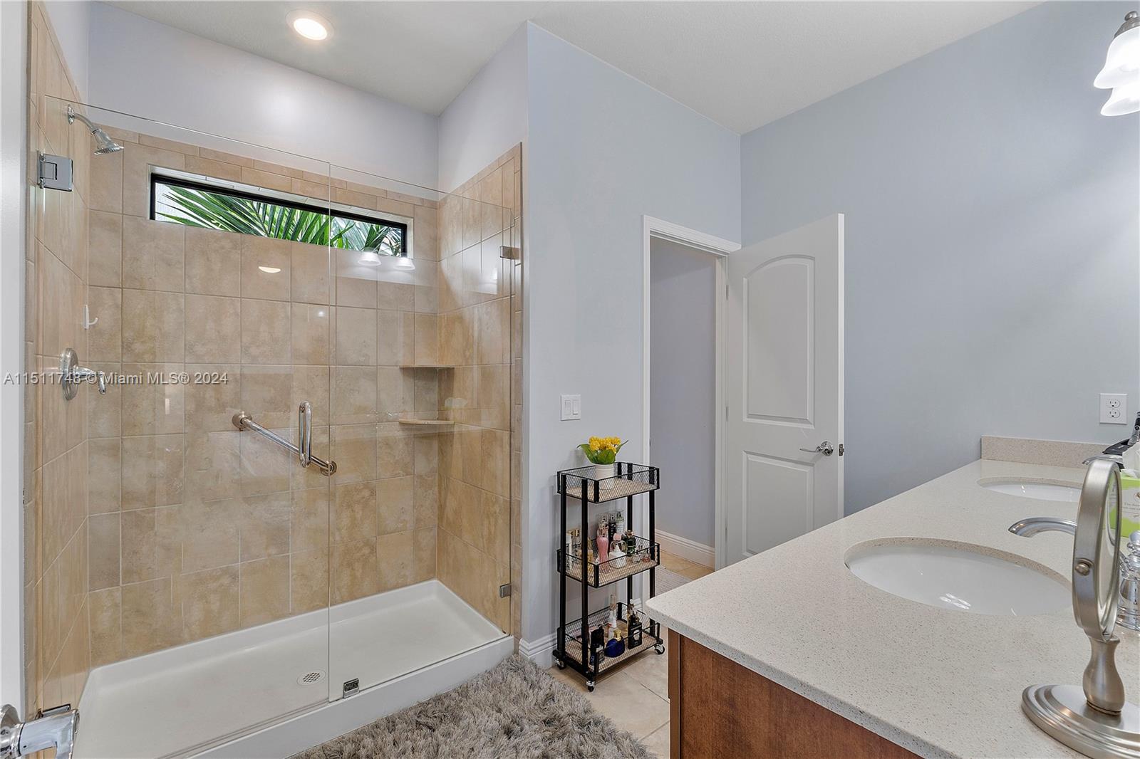 8339 Cadre Noir Road Lake Worth, FL 33467 - Photo 33 of 44 a bathroom with a sink and a mirror